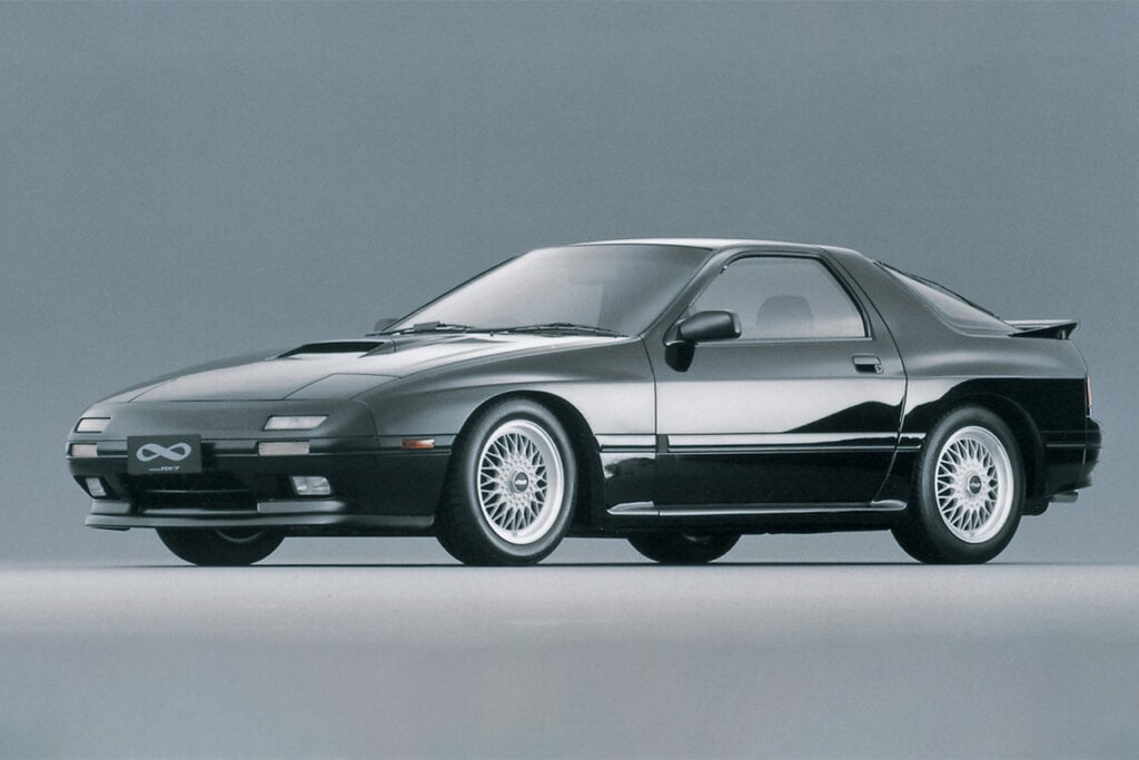 black Mazda rx7 FC on a grey background