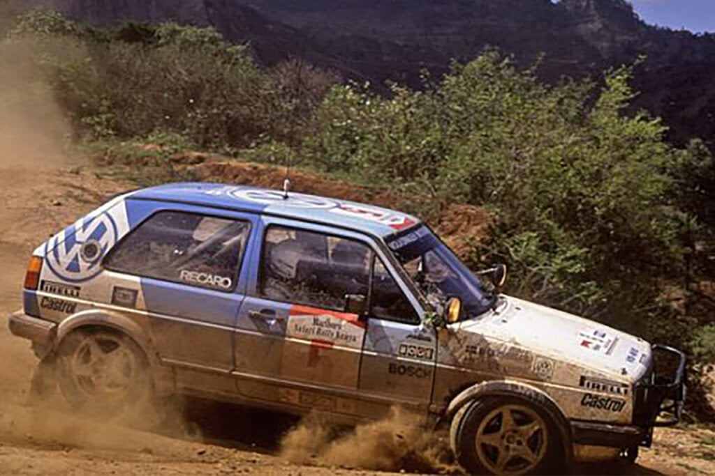 Volkswagen GTI-R rallye drifting through a dirt turn