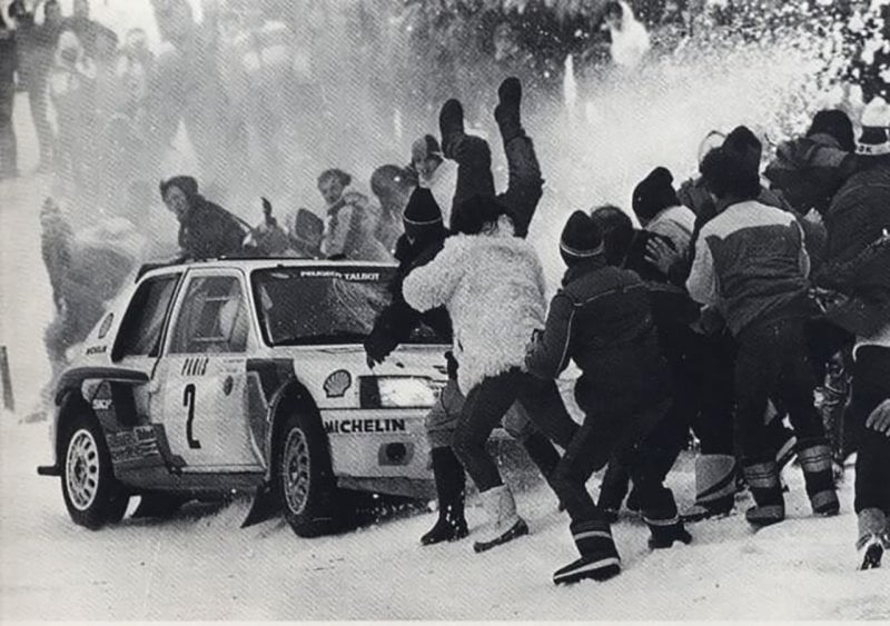 black and white photo of a car hitting spectators
