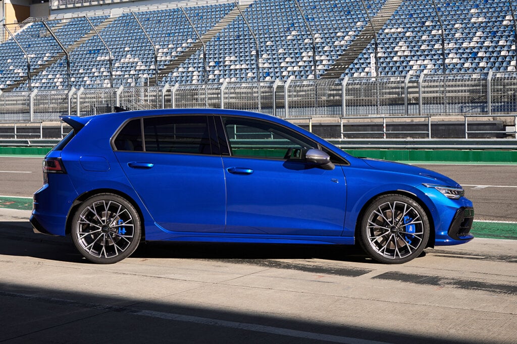 Side profile shot of a blue 2025 Golf R on an empty racetrack