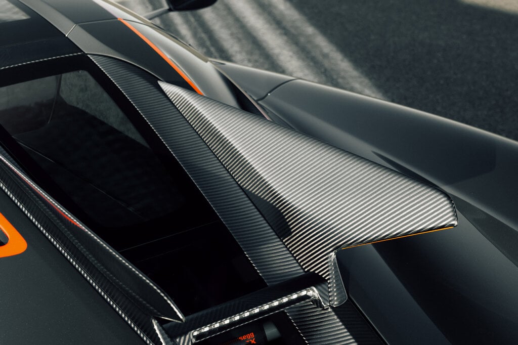 carbon fiber details with orange accents on a car