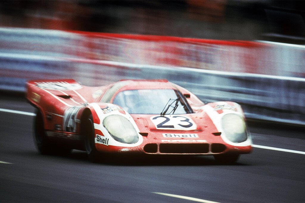 red porsche 917 kh racing on a track